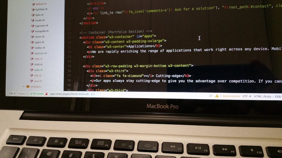 Close-up view of a MacBook Pro displaying a webpage editing code with HTML tags such as <section>, <div>, <h1>, and <p>. The screen shows a text editor with color-coded syntax highlighting for differe